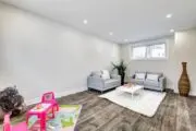 finished basement with luxury vinyl flooring and play area