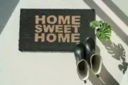 A mat reading "home sweet home" - homeowners not moving