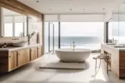 oval white soaker tub placed in front of an oceanview window with wooden cabinets