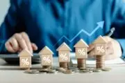 Home price increases - miniature wooden houses stacked on coins