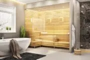 primary bathroom, with oval standalone bathtub, with a small sauna nearby